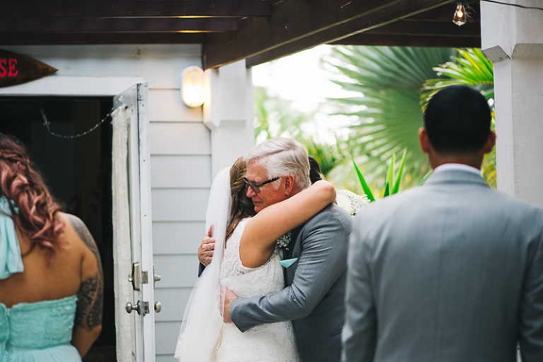 father of the bride crying and hugging bride