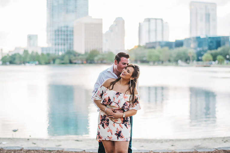 soon to be bride and groom having an engagement session in downtown orlando fl lake eola