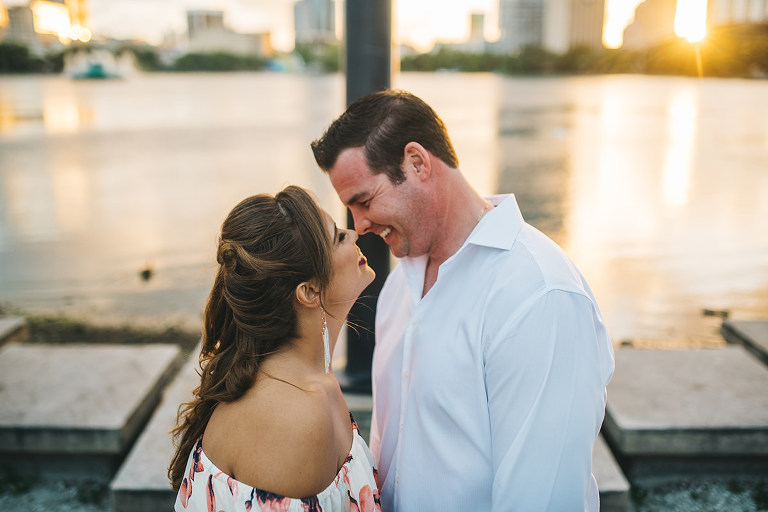 cute engagement pictures at lake eola downtown laughing couple