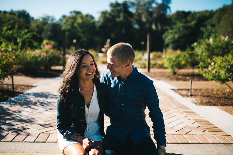 couple in rose garden in leu gardens laughing candidly during engagement session