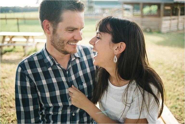 cute engagement picture of laughing couple in sweetfields farm