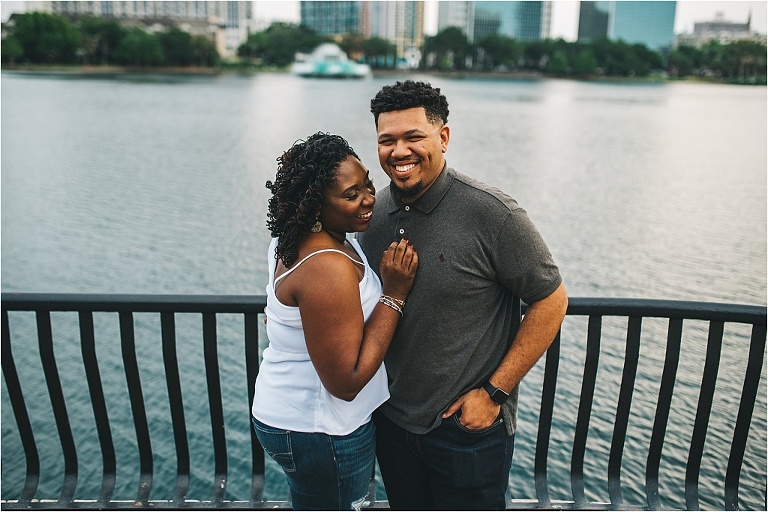 couple laughing candidly during engagement session in downtown orlando lake eola
