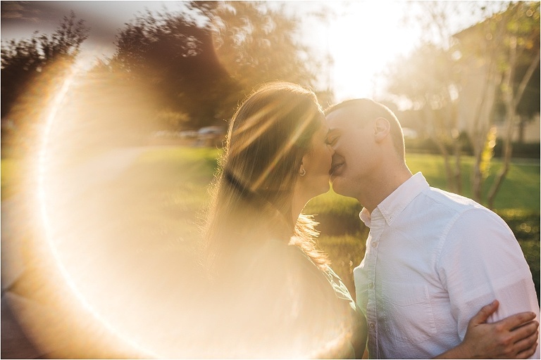 couple kissing during engagement pics solar flare ring of fire photo rollins college courtyard
