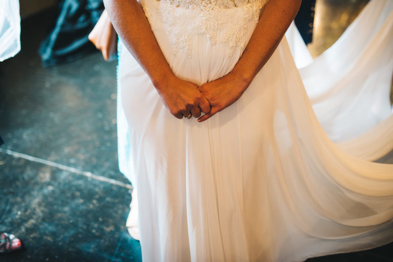 bride holding hands tightly right before wedding ceremony