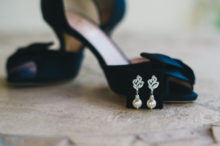 detail photograph of bride earrings on kate spade blue suede shoes