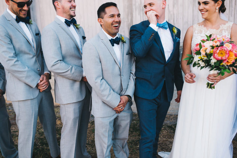candid moment between the bride groom and groomsmen