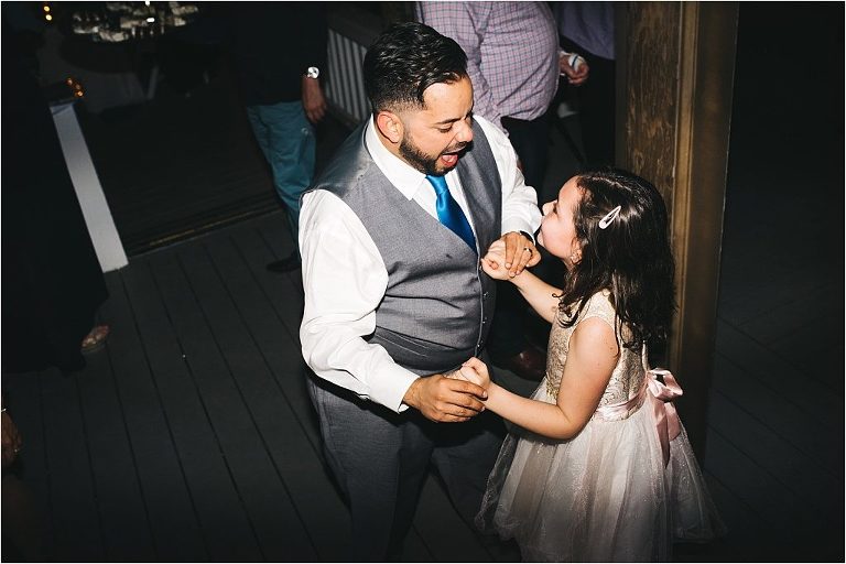groom dancing with flower girl