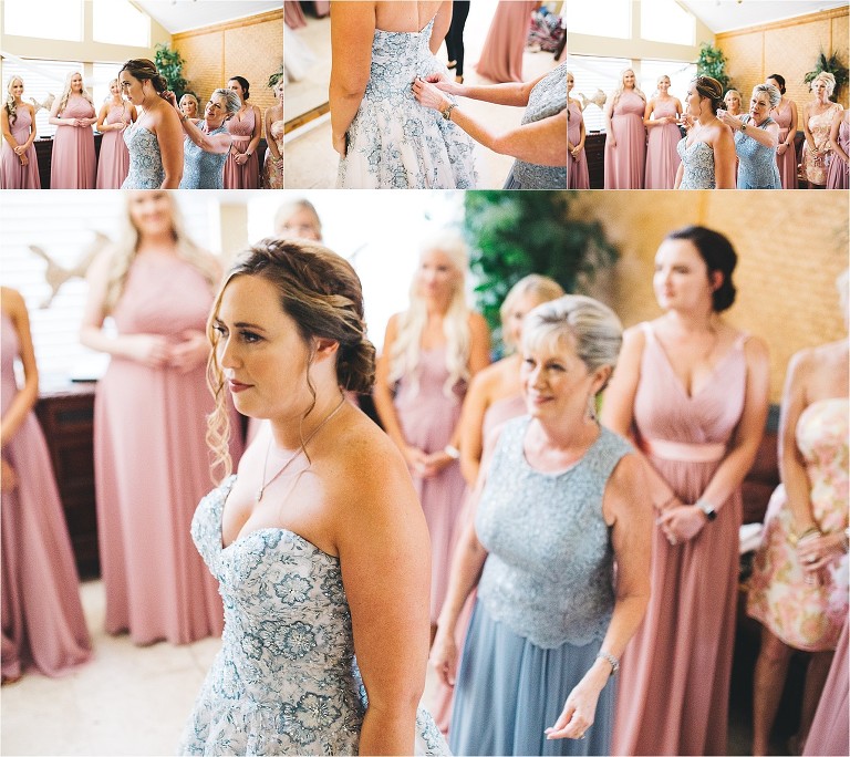mother of the bride helping her daughter put on finishing touches