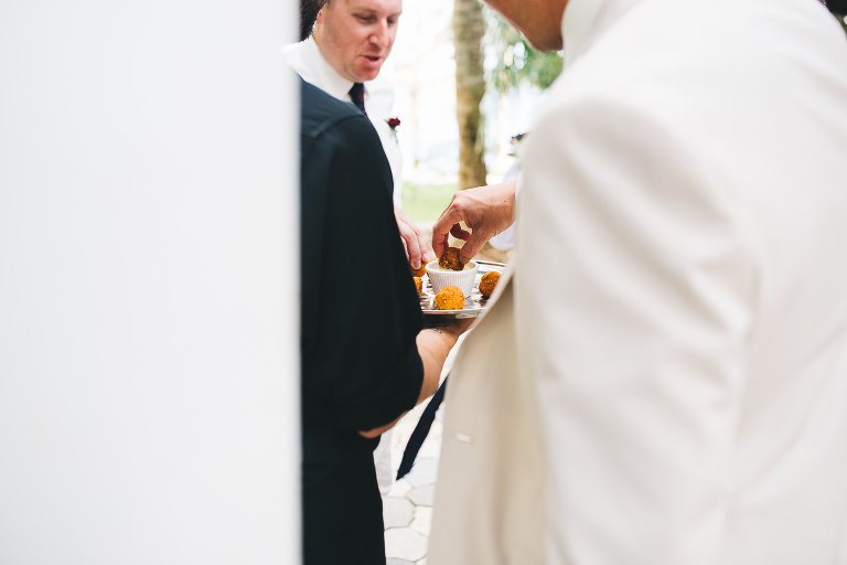groom grabbing something to eat after wedding ceremony