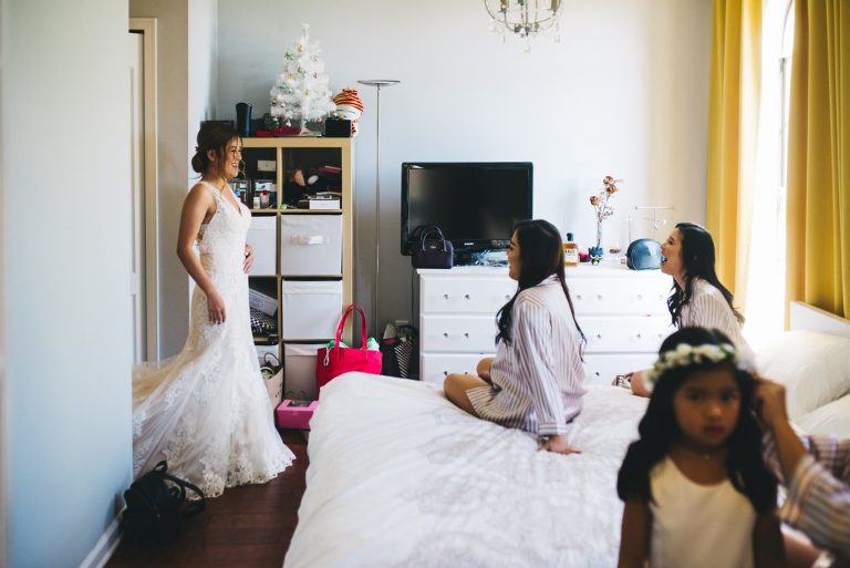 bridesmaids seeing bride for the first time in her dress