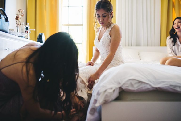 bride getting help getting dressed