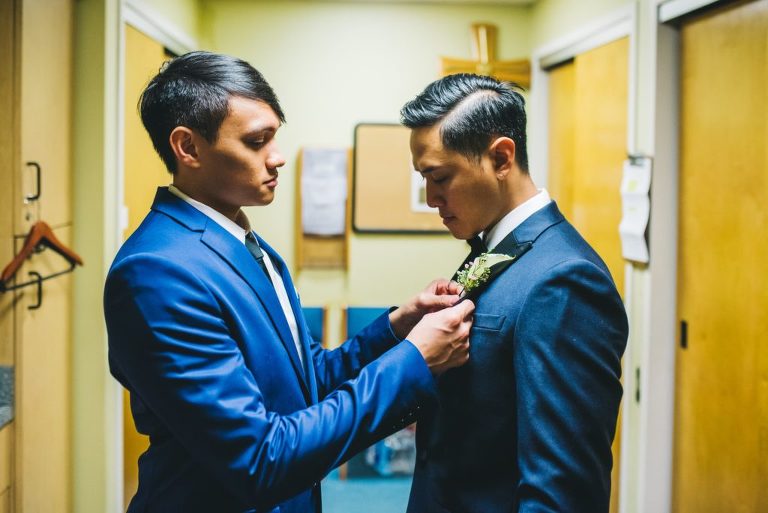 best man helping groom get ready