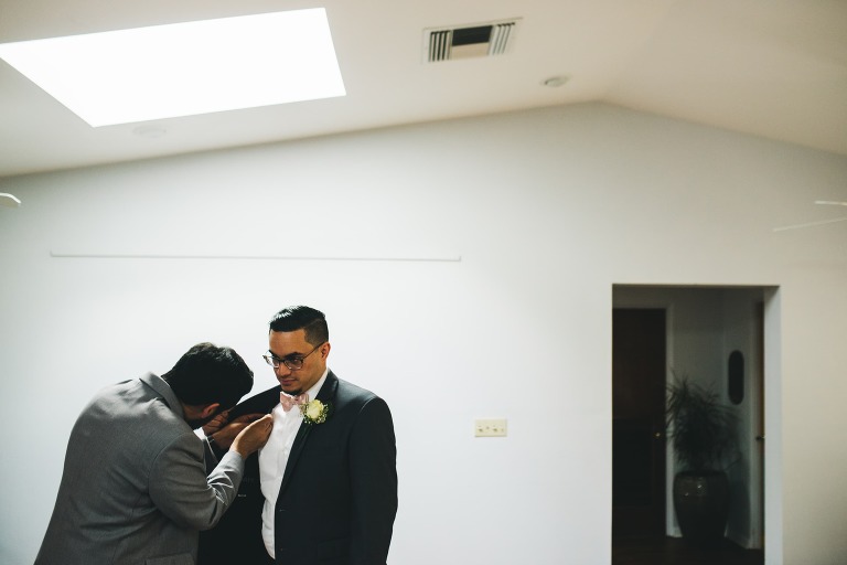 best man helping groom get ready
