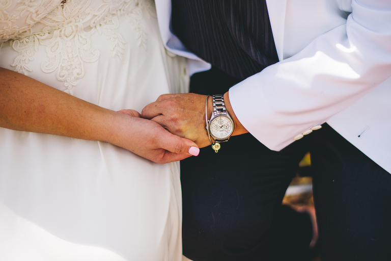 couple holding hands wedding pictures